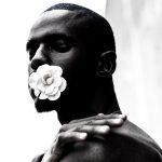man with flower in his mouth